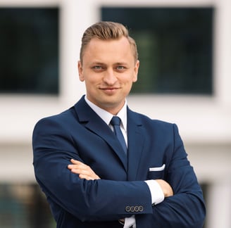a man in a suit and tie standing in front of a building