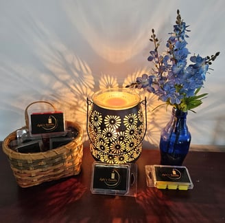 a table with a candle and a vase with flowers