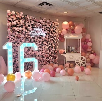 Sweet 16 birthday celebration with our pink rose flower wall and the 16 Marquee sign