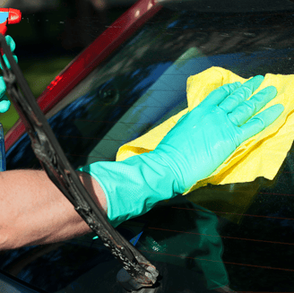 a person in gloves and gloves cleaning a car