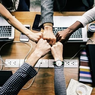 a group of people holding hands in a circle