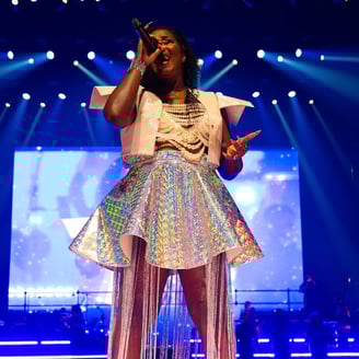 a woman in a white dress and a microphone