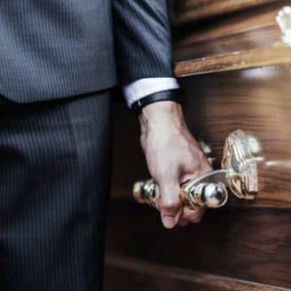 a close up of a pall bearer holding a coffin's handle