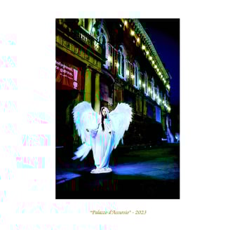 a woman in a white dress with angel wings palazzo  d'accursio