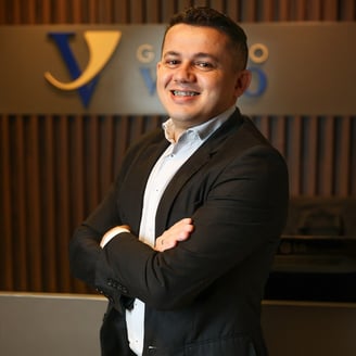 a man in a suit and tie smiling for the camera