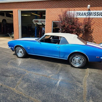 a blue car parked in front of a building