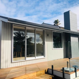 a house with a deck and a deck with a view of the ocean