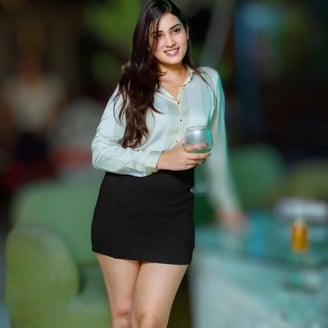 a woman in a short skirt and a white shirt AT kokkinia Nightclub