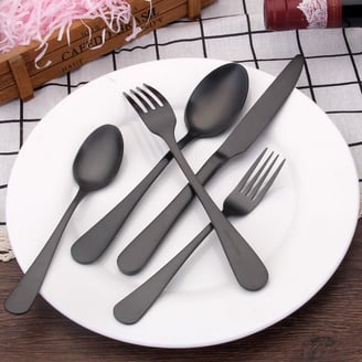 a plate with spoons and forks on a table