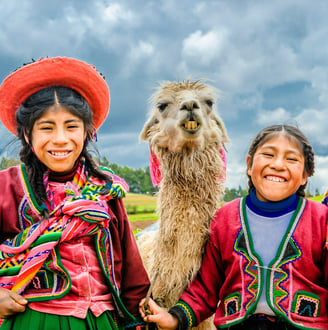 two happy kids from the Andes with a llama.  Dos ninos felices de los Andes con una llama