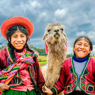 two happy kids from the Andes with a llama.  Dos ninos felices de los Andes con una llama
