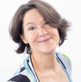 a woman with a haircut and a white shirt