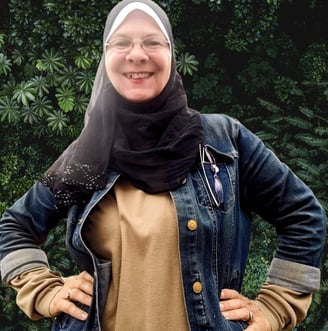 a woman wearing a hijab and smiling
