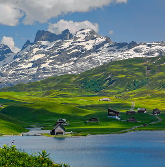 a mountain range with a lake and mountains in the background