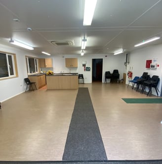 a room with a large open space with chairs and a table