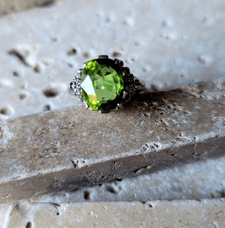 Peridot ring placed on limestone rock