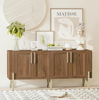a wooden sideboard with a vase of flowers and a vase of flowers
