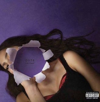 a woman lying on a purple background