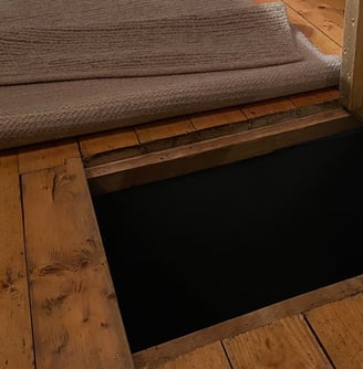 a door way with a door open and a rug rug on the floor