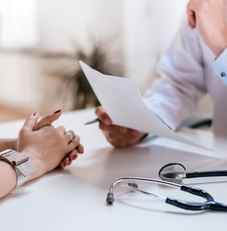 a doctor and a woman sitting at a desk