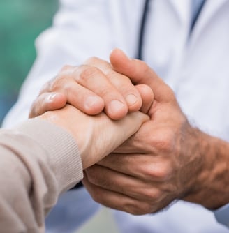 a doctor shaking hands with a patient