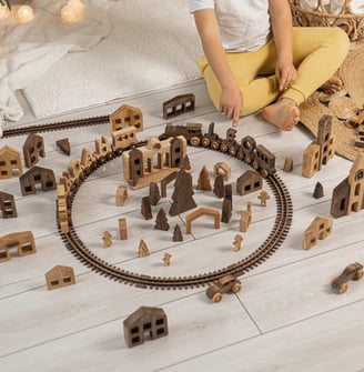 a child's play area with a train set up on the tracks