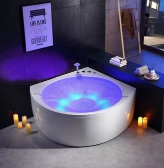 a bathtub with candles and candles on a table