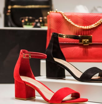 a pair of red shoes and a purse