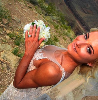 bride photo at grand canyon showing wedding ring and flowers