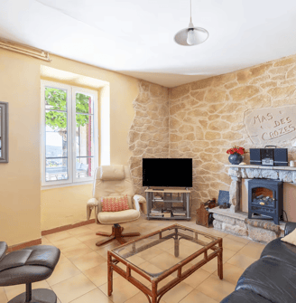 a living room with a fireplace and a stone fireplace