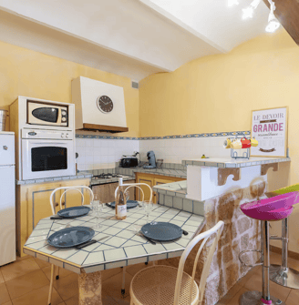 a kitchen with a table and chairs and a refrigerator