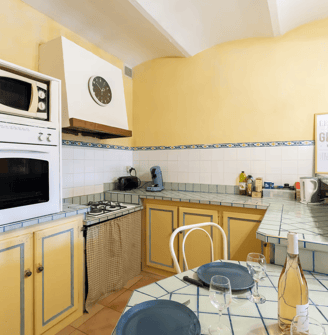 a kitchen with a table and chairs and a microwave
