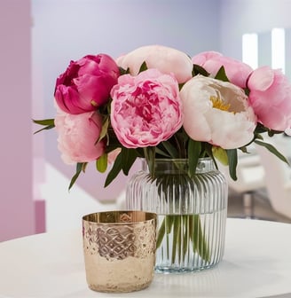 a vase with pink flowers in a salon