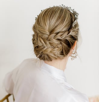 Braided updo for blonde bride on her wedding day Atmosphere Photography