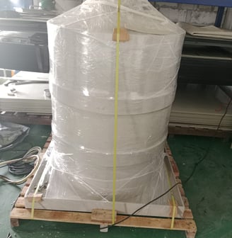 a large stack of white plastic bags on a pallet