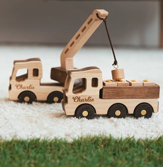 a wooden toy truck with a crane on it