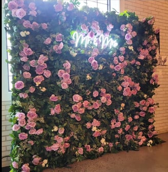 Juliette flower wall with a Mr & Mrs neon sign for a wedding reception at the Eglington West Gallery