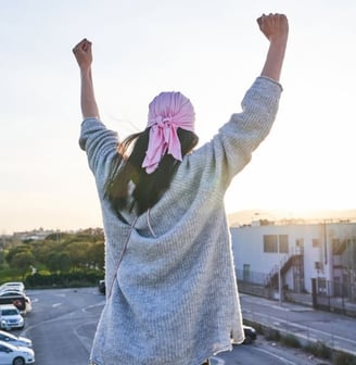 a woman with a pink scarf around her neck