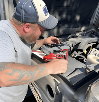 Mechanic working under hood of a car
