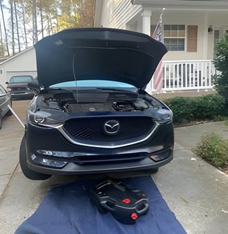 image of car with oil pan under it