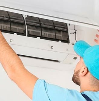 a man in a blue shirt is holding a blue hat