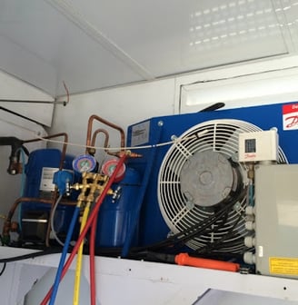 a blue and white air conditioner with a fan and a fan