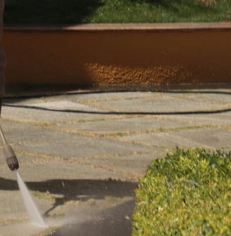 man cleans stone floor with high pressure lance. photo by Sincegameon