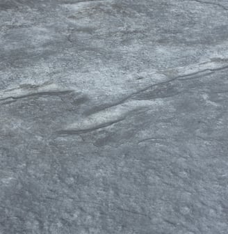 A soft stone slate featuring a unique black and gold veining pattern, ideal for elegant wall designs