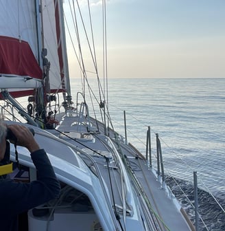 a man is taking a picture of a sailboat