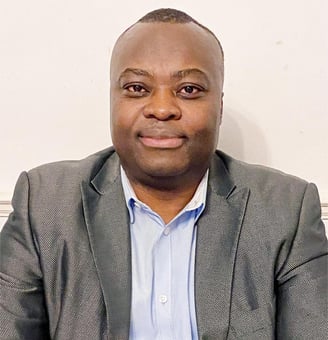 a man in a suit and tie is smiling