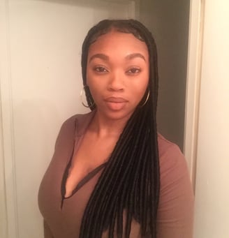 a woman with long hair and a brown top
