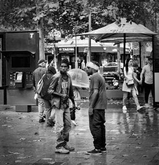 Two aboriginal men in a face-to-face discussion in the street photographed by Peter Pickering