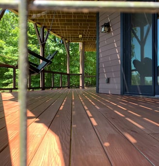 Close up image of newly installed deck in a home in Hickory, NC. Dark red deck coated and installed