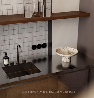 Modern sink area with a stainless steel countertop, white tiled backsplash, and a decorative bowl.